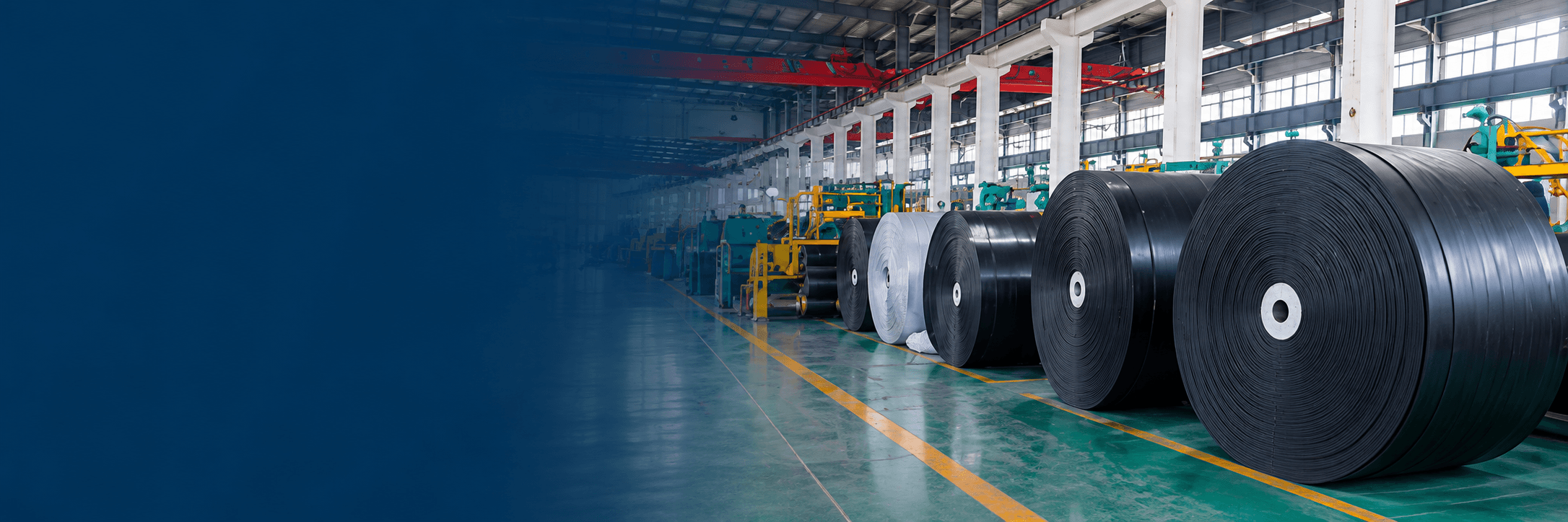 Illustrative conveyor belt rolls in a production hall